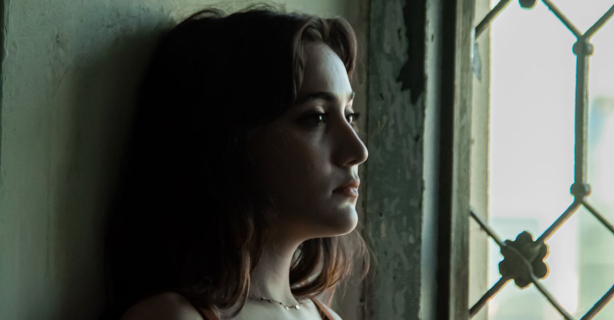 Thoughtful person by a window